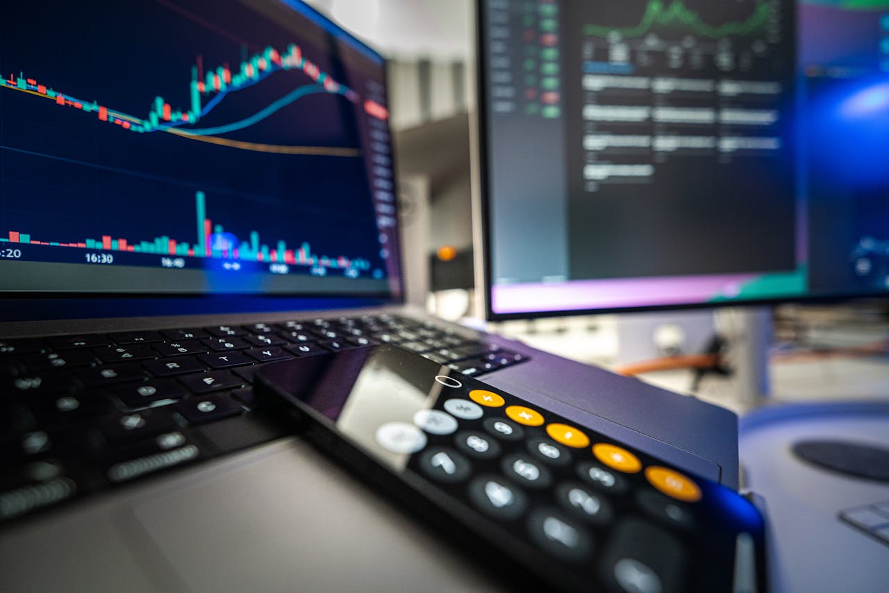 Various computer screens with financial charts.